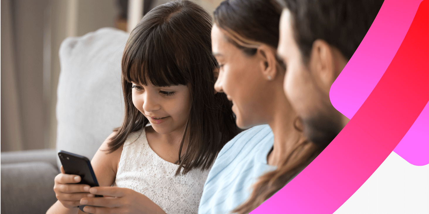 Family on a sofa with a young girl using a smart phone